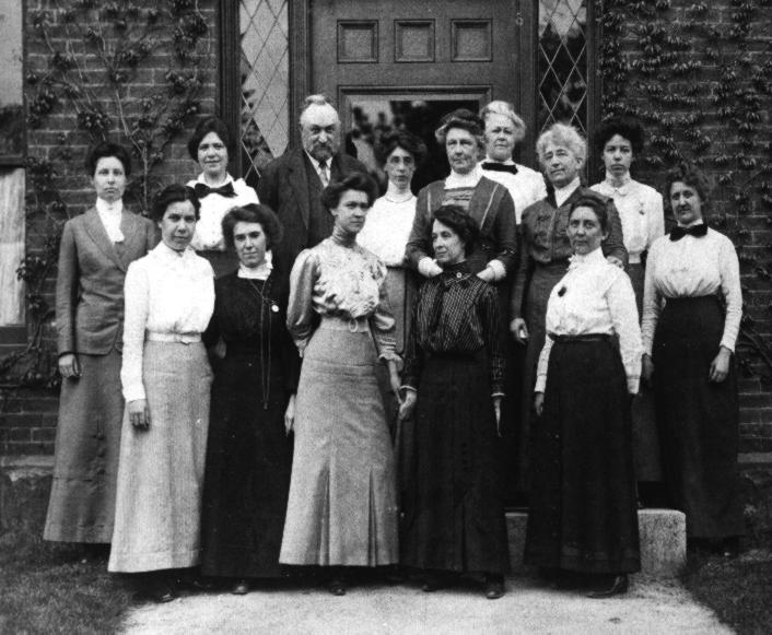  Photograph of the Harvard Computers, a group of women who worked under Edward Charles Pickering at the Harvard College Observatory. The photograph was taken on 13 May 1913 in front of Building C, which was then the newest building at the Observatory. The image was discovered in an album which had once belonged to Annie Jump Cannon. Image courtesy of the Harvard-Smithsonian Center for Astrophysics. Back row (L to R): Margaret Harwood (far left), Mollie O'Reilly, Edward C. Pickering, Edith Gill, Annie Jump Cannon, Evelyn Leland (behind Cannon), Florence Cushman, Marion Whyte (behind Cushman), Grace Brooks. Front row: Arville Walker, unknown (possibly Johanna Mackie), Alta Carpenter, Mabel Gill, Ida Woods (Source: Harvard-Smithsonian Center for Astrophysics. This media file is in the public domain because its copyright has expired). 
